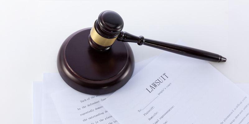 Illustration of a person filing a claim in the Ontario Small Claims Court, placing a completed form in a tray with a courthouse in the background.